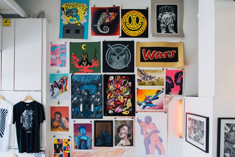urban-themed prints and T-shirts hanging on a wall.