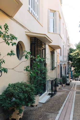 a part of what seems to be a narrow pedestrian, street at the entrance of a house