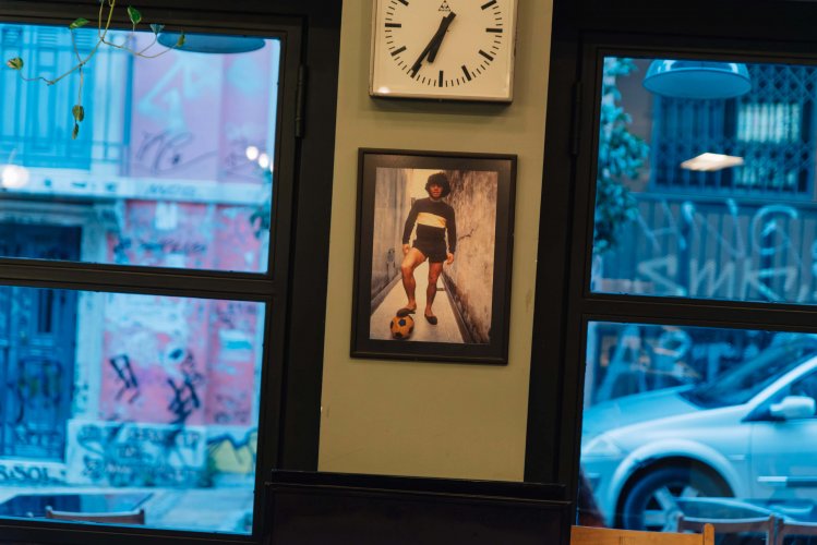 a picture of a man stepping on a football, on a wall of a store