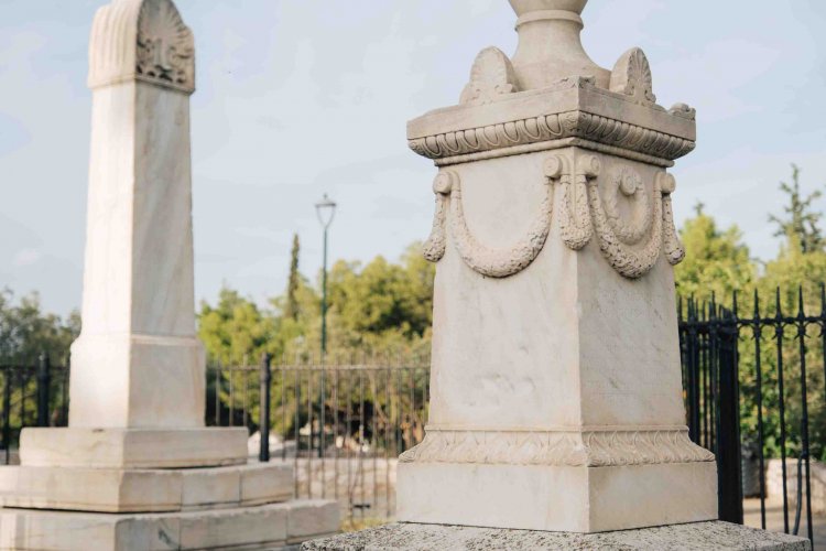 close up of two monuments, trees at the background.