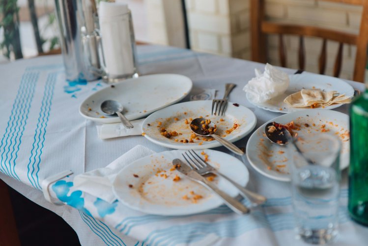 a table with empty plates after a lunch