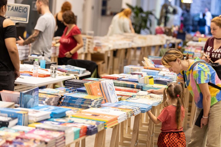 people shopping for books and magazines at an indoor flea market