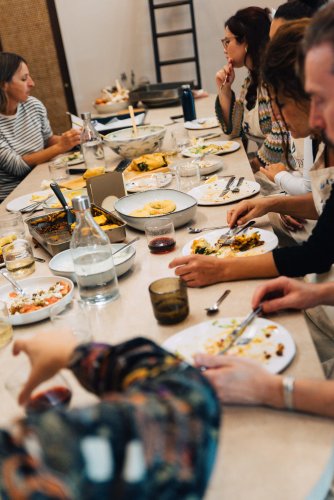 people having lunch around a table.