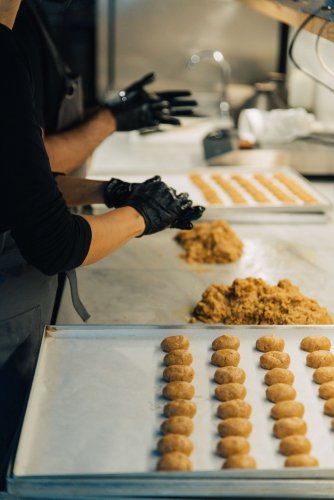 chefs preparing dough wearing gloves.