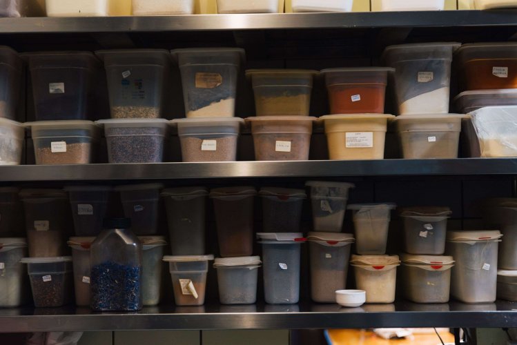 selves with plastic containers of different ingredients and spices.