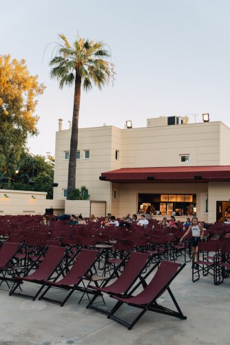 an open-air cinema and its bar, trees behind