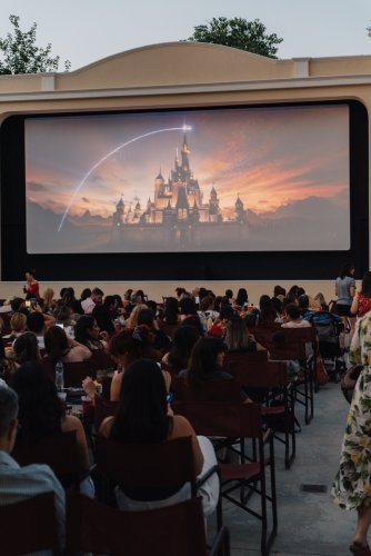 people watching a movie at an open-air cinema.