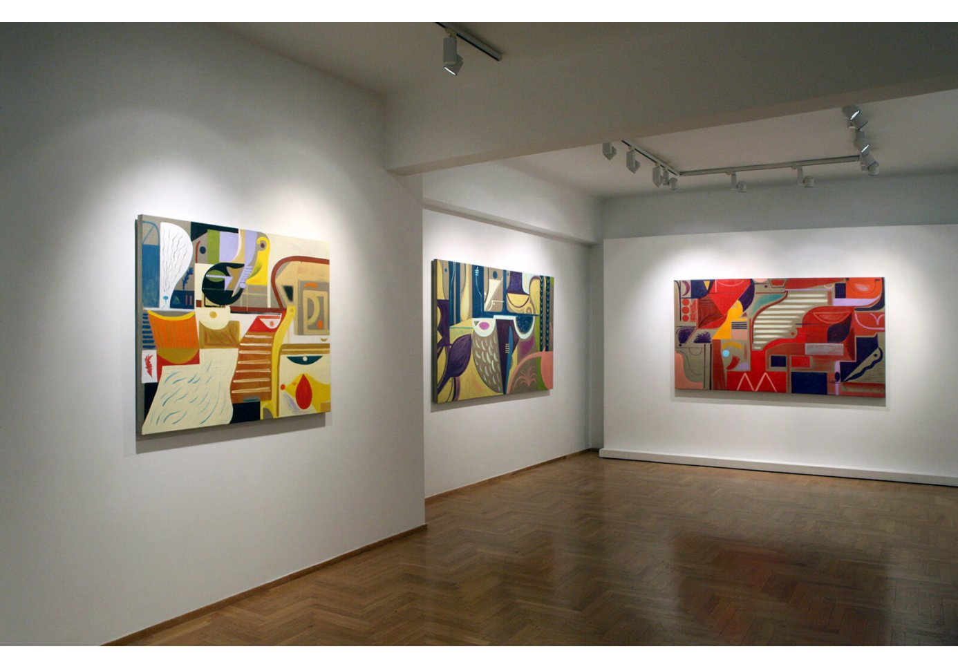 Three paintings in a gallery room