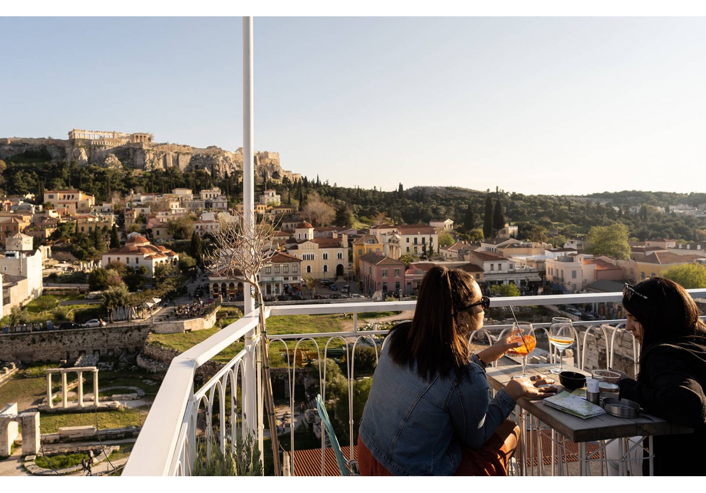 Two people having a drink at Anglais rooftop bar in Athens. 