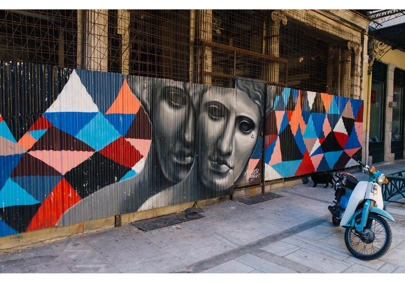 Faces in Love by Achilles and Onebran graffiti mural on Aiolou street in Athens.