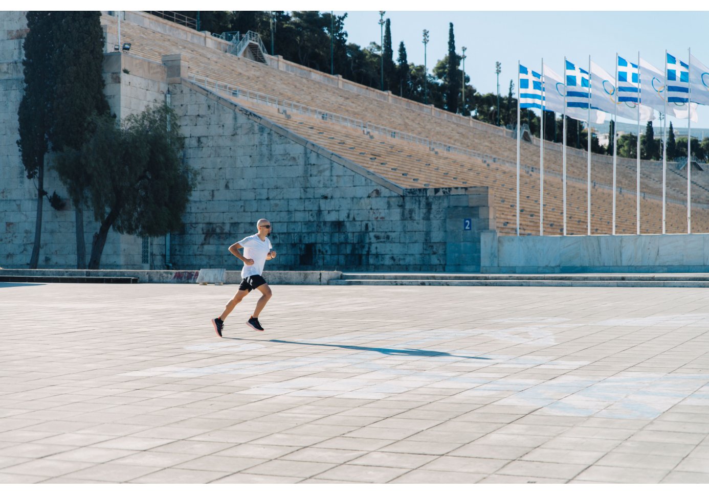 A man running in front of the Panathenaic Stadium in Athens