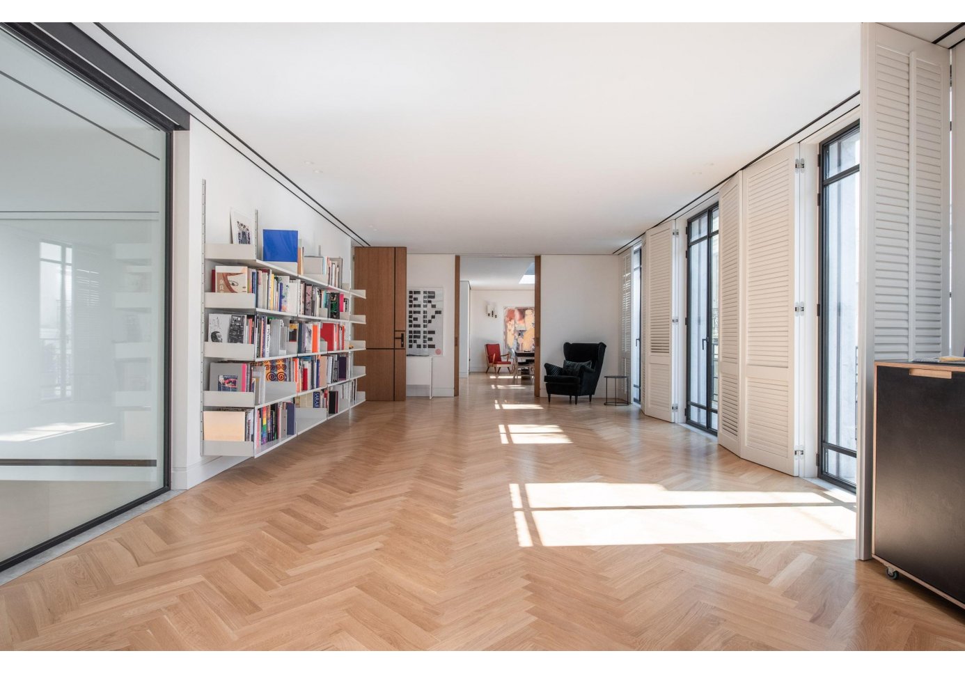 the inside of the gallery, light through and through, a library.