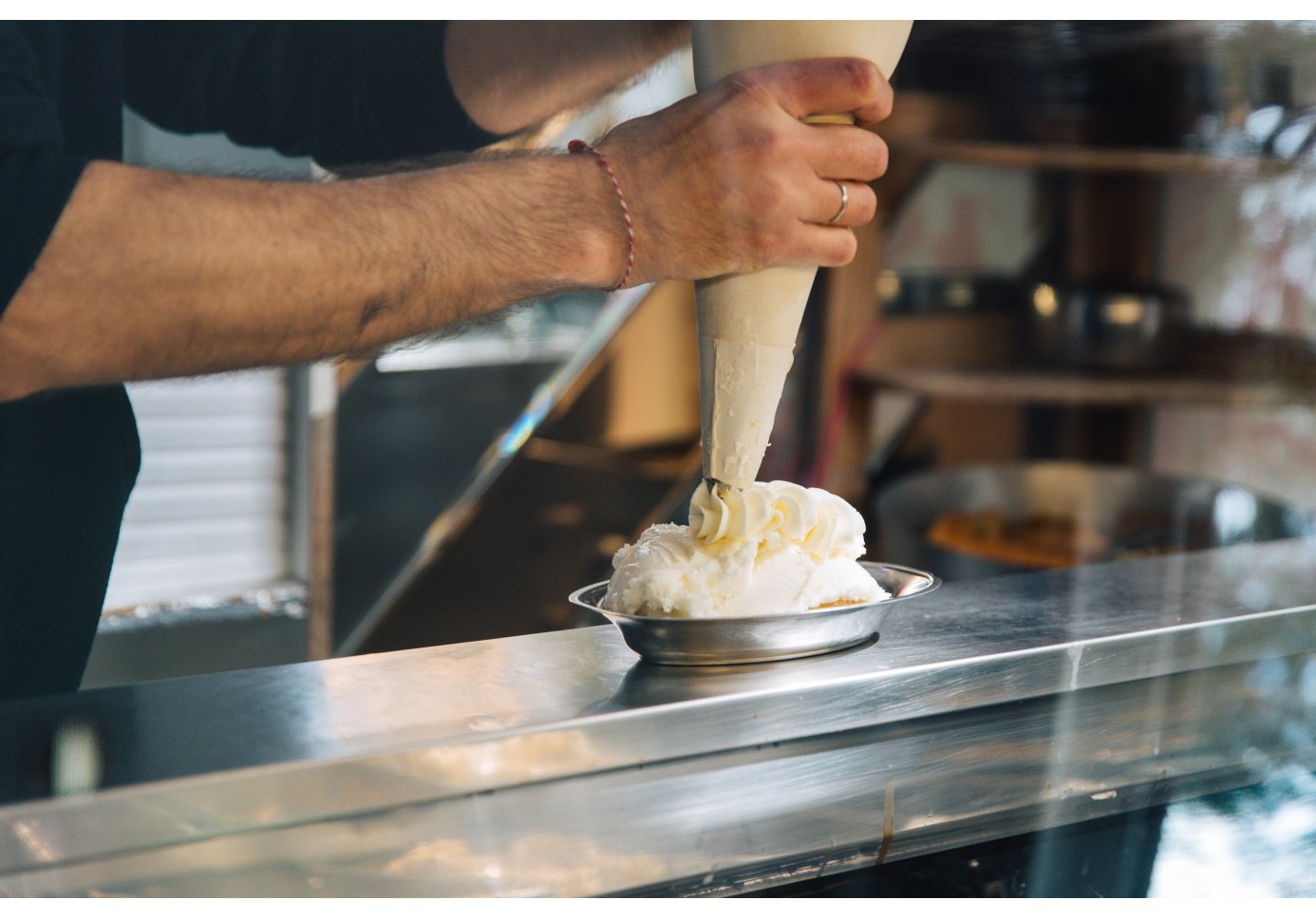 a man adding cream on top of a dessert.