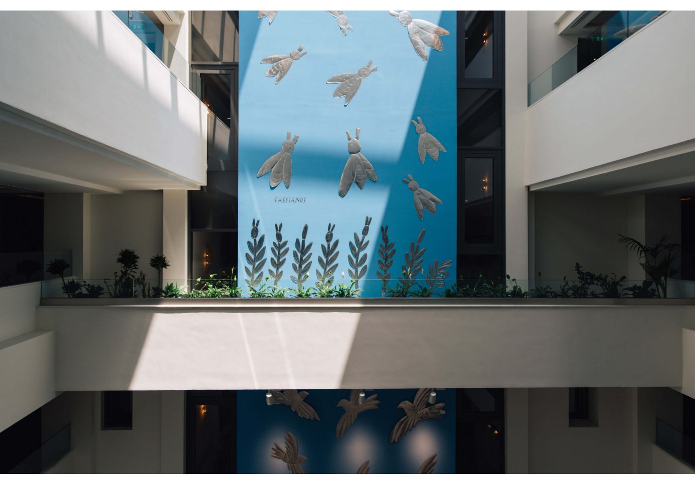 an atrium with a large-scale installation of birds.