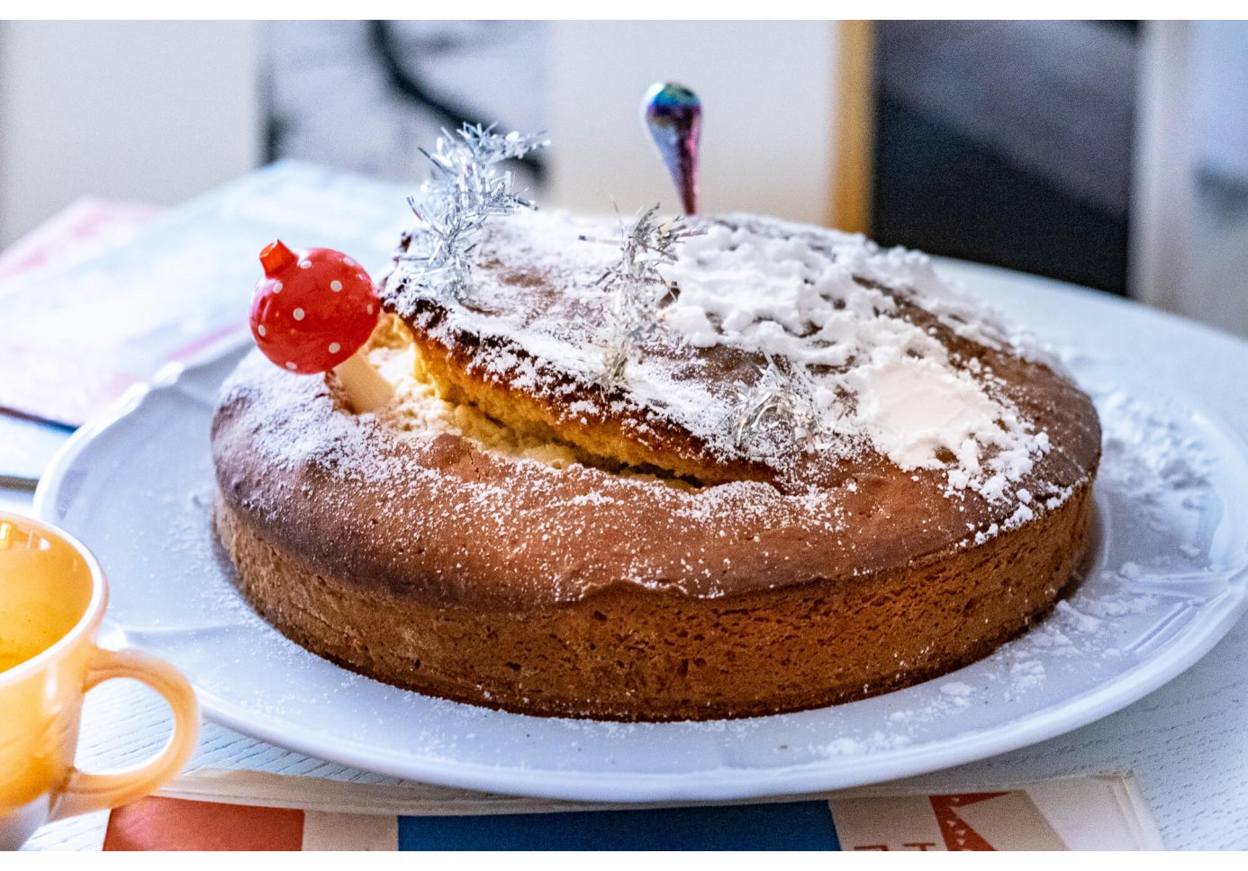 a powdered sugar vanilla cake decorated with christmas ornaments