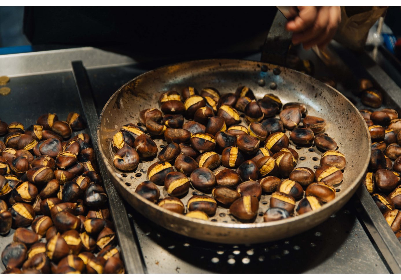 A pan filled with roasted chestnuts. 