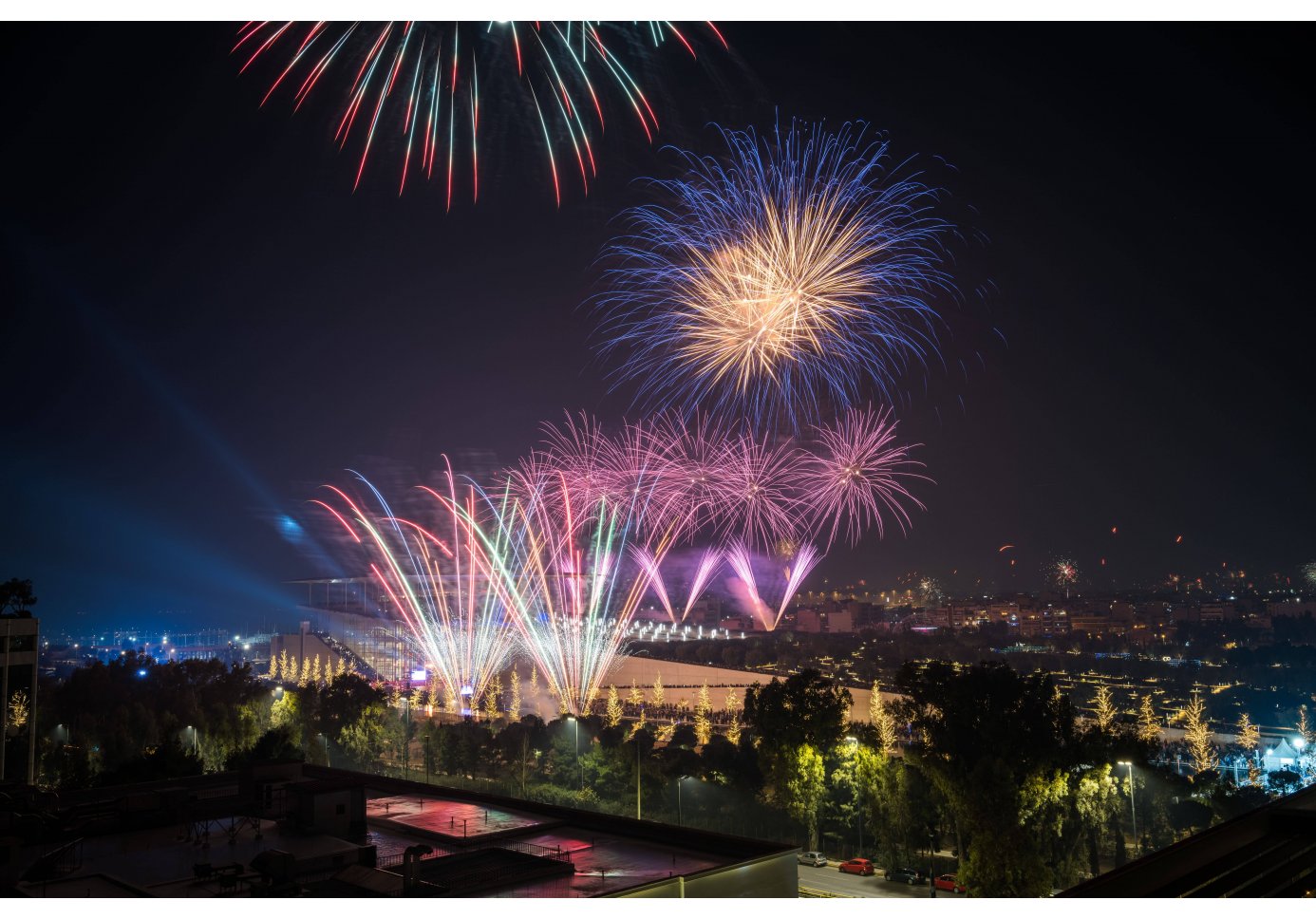 fireworks over a big building complex, night-time