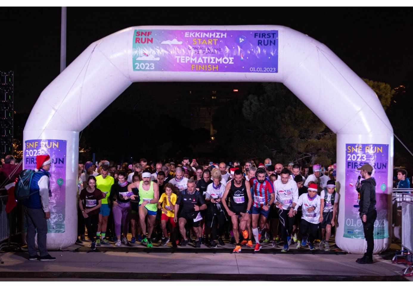people at the starting line of a race, night-time
