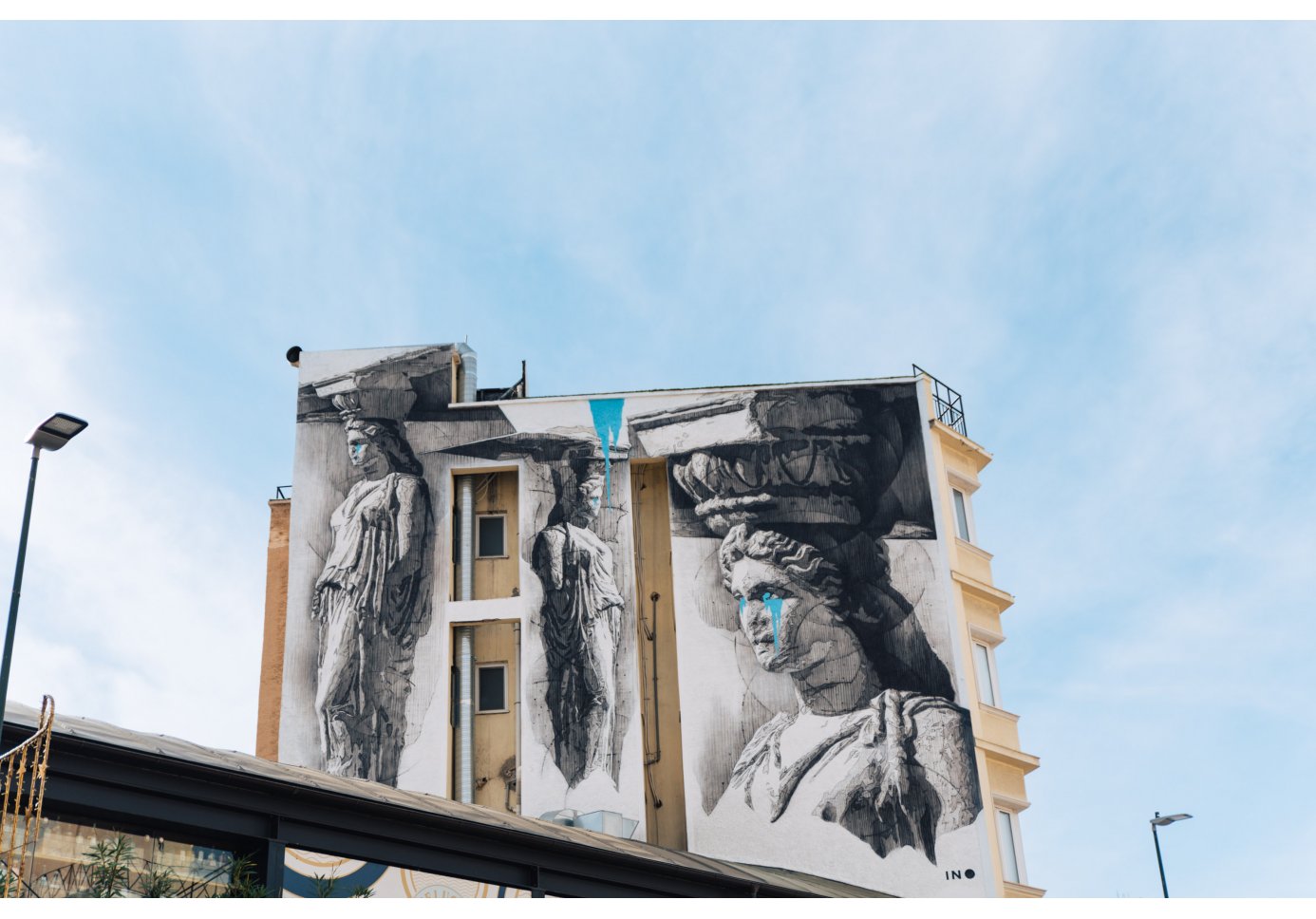 a mural of three caryatids, day time