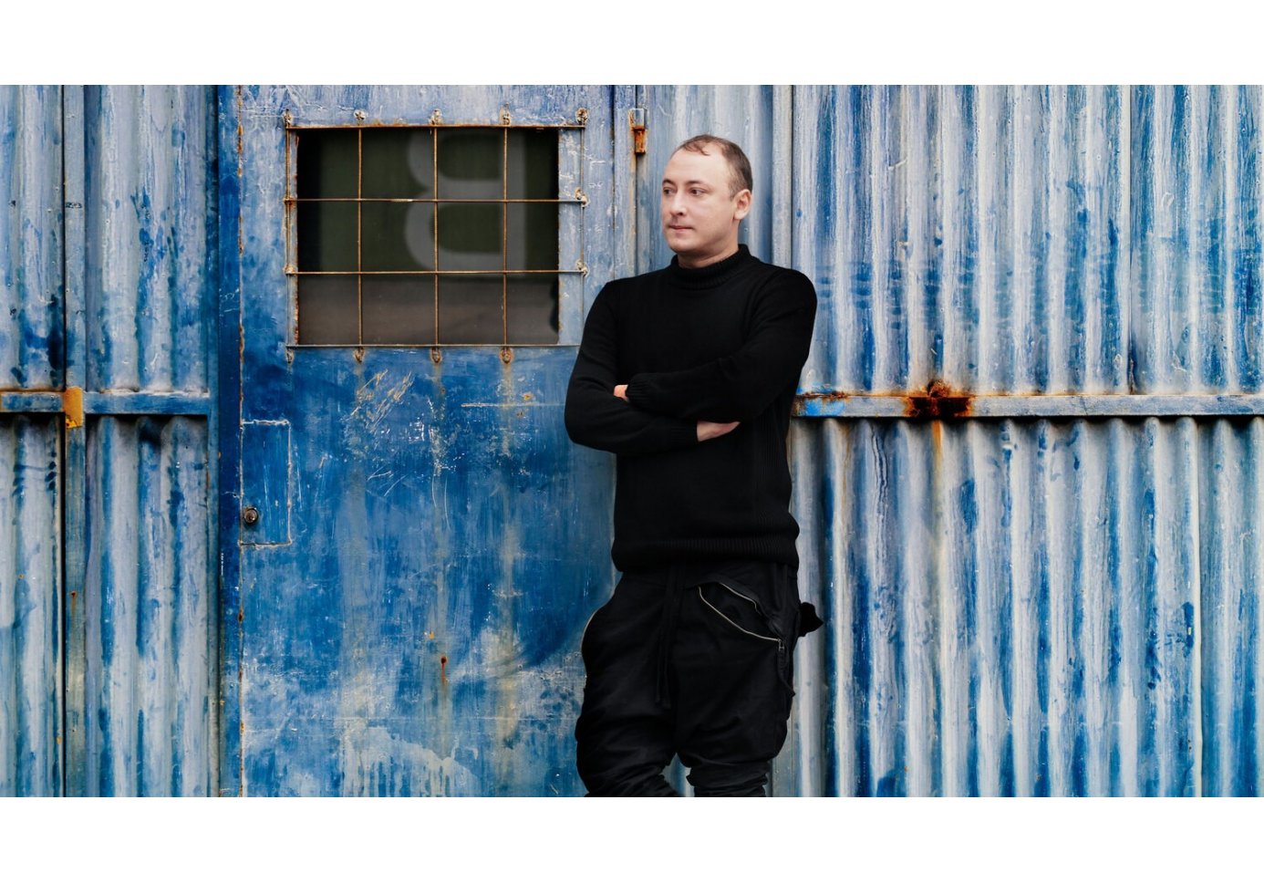 a man standing outside a warehouse